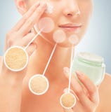 Woman applies cream on face