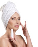 Woman applying cream for face stock image Woman applying cream for face stock image