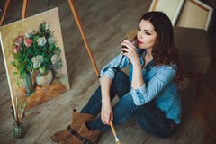 Woman artist painting a picture in a studio Royalty Free Stock Photo Woman artist painting a picture in a studio Royalty Free Stock Photo