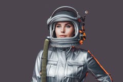 Woman astronaut wearing space helmet and suit