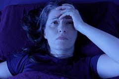 Woman awake bed night insomnia