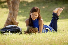 Woman with books and ipad studying for college test