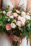 Bride holding pink rose wedding bouquet stock photo Bride holding pink rose wedding bouquet stock photo