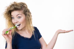Woman brushing teeth holds open hand Stock Image Woman brushing teeth holds open hand Stock Image