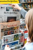 Woman buying The New York Times newspaper royalty free stock image Woman buying The New York Times newspaper royalty free stock image