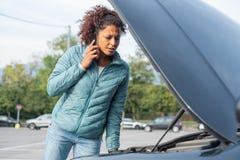 Woman calling mechanic service after vehicle problem royalty free stock photography Woman calling mechanic service after vehicle problem royalty free stock photography
