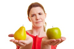 Woman comparing apple and pear Royalty Free Stock Photo Woman comparing apple and pear Royalty Free Stock Photo