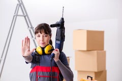 The woman contractor with hand drill at construction site stock images The woman contractor with hand drill at construction site stock images