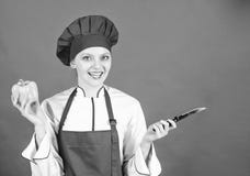 Woman in cook hat and apron. professional chef in kitchen. Cuisine. sweet pepper. happy woman cooking healthy food by royalty free stock photography Woman in cook hat and apron. professional chef in kitchen. Cuisine. sweet pepper. happy woman cooking healthy food by royalty free stock photography