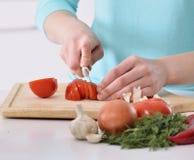 Woman cooking in new kitchen making healthy food with vegetables. Royalty Free Stock Photos Woman cooking in new kitchen making healthy food with vegetables. Royalty Free Stock Photos