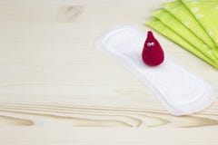 Woman critical days. Menstruation sanitary soft pad for woman hygiene protection and crochet funny blood drop. Gynecological menst royalty free stock photography Woman critical days. Menstruation sanitary soft pad for woman hygiene protection and crochet funny blood drop. Gynecological menst royalty free stock photography