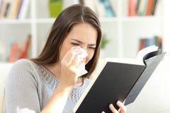 Woman crying while is reading a paper book at home stock photography Woman crying while is reading a paper book at home stock photography