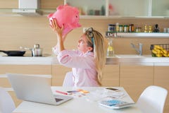 Woman desperately searhing for some money in piggy bank Stock Images Woman desperately searhing for some money in piggy bank Stock Images