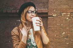 https://thumbs.dreamstime.com/t/woman-drinking-coffee-stylish-brick-wall-background-55084894.jpg