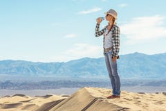 Woman drinking water in desert. Active girl quenches thirst in Death Valley, California, USA stock image Woman drinking water in desert. Active girl quenches thirst in Death Valley, California, USA stock image