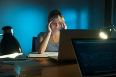 Woman With Eyes Tired Working Late At Night In Office