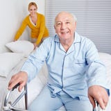 Woman Fixing Bed For Senior Man Stock Photos Woman Fixing Bed For Senior Man Stock Photos