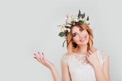 woman with floral headband showing beauty product empty copy space stock photo woman with floral headband showing beauty product empty copy space stock photo
