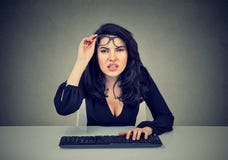 Woman in glasses using computer has vision problems stock photography Woman in glasses using computer has vision problems stock photography