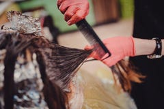 Woman in gloves is dying hair stock photography Woman in gloves is dying hair stock photography