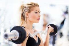 Woman in gym lifting weights