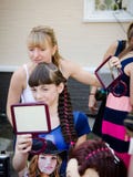 Woman hairdresser shows the girl who has done her hair, the look royalty free stock image Woman hairdresser shows the girl who has done her hair, the look royalty free stock image