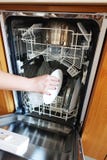 Woman hand putting dirty dishes in dishwasher royalty free stock images Woman hand putting dirty dishes in dishwasher royalty free stock images