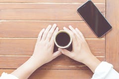 Woman hands holding a cup of hot coffee stock photo Woman hands holding a cup of hot coffee stock photo