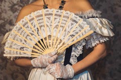 Female hands keep a lacy fan in openwork gloves Royalty Free Stock Image Female hands keep a lacy fan in openwork gloves Royalty Free Stock Image