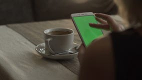 Woman hands touching on green screen mobile phone on background coffee cup stock video Woman hands touching on green screen mobile phone on background coffee cup stock video