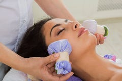 Woman has herbal ball massage in ayurveda spa wellness center royalty free stock photos Woman has herbal ball massage in ayurveda spa wellness center royalty free stock photos
