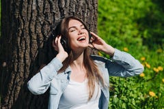 Woman with headphones in park