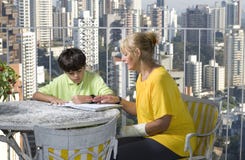 Woman helping boy write - Horizontal Stock Images Woman helping boy write - Horizontal Stock Images