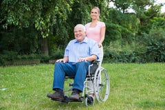 Woman With Her Disabled Father On Wheelchair royalty free stock photography Woman With Her Disabled Father On Wheelchair royalty free stock photography