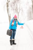 Woman hitchhiking on road snow gas can Stock Images Woman hitchhiking on road snow gas can Stock Images
