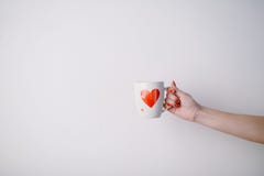 Woman Holding Cup With Heart Shape. Close Up Stock Images