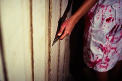 A Woman holding knife with blood, halloween concept stock photography A Woman holding knife with blood, halloween concept stock photography