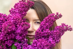 Woman holding a large bouquet of lilac flowers close up stock image Woman holding a large bouquet of lilac flowers close up stock image