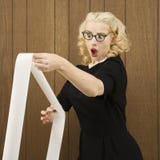 Woman holding a printout with a shocking expression on her face. Stock Photos Woman holding a printout with a shocking expression on her face. Stock Photos