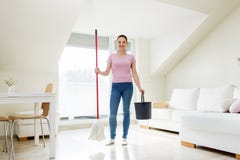 Woman or housewife with mop cleaning floor at home Royalty Free Stock Image Woman or housewife with mop cleaning floor at home Royalty Free Stock Image