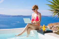 Woman In Bikini Working With Laptop By Swimming Pool Stock Photos