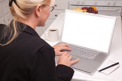 Woman In Kitchen Using Laptop With Blank Screen Stock Photos