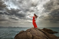 Woman In Red Dress Stands On A Cliff With A Beautiful Sea View A Royalty Free Stock Photo Woman In Red Dress Stands On A Cliff With A Beautiful Sea View A Royalty Free Stock Photo