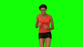 Woman jogging on green screen