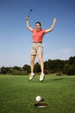 Woman jumping over good golf shot.