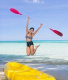 Woman jumping with a paddle stock photos Woman jumping with a paddle stock photos