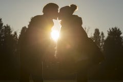 Woman kissing partner outdoors