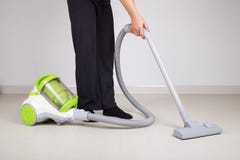 Woman legs with vacuum cleaner cleaning floor stock photography Woman legs with vacuum cleaner cleaning floor stock photography