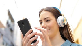 Woman listening to music checking songs stock footage Woman listening to music checking songs stock footage
