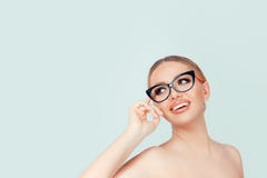 Woman looking up to the side touching eyeglasses isolated on light green royalty free stock photos Woman looking up to the side touching eyeglasses isolated on light green royalty free stock photos